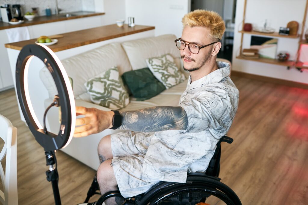 Man Using Ring Light While Sitting in Modern Living Room